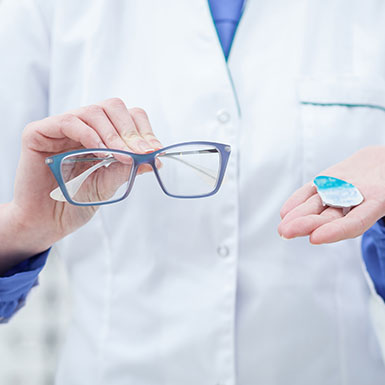 Eye Doctor Holding Glasses